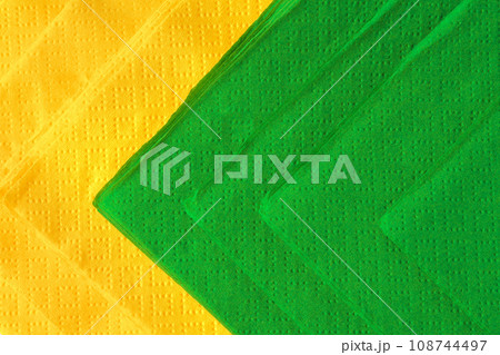 Green and yellow paper napkins on white background 108744497