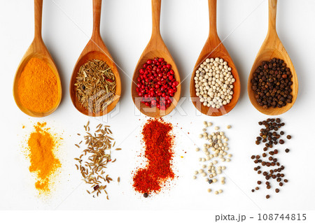 Wooden spoons with various spices isolated on white background Wooden spoons with various spices isolated on white background 108744815