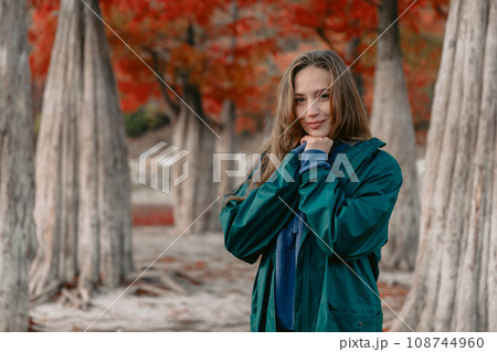 Young attractive woman walking down the park. Beautiful lady looking at the camera. Young attractive woman walking down the park. Beautiful lady looking at the camera. 108744960