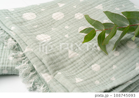 Green muslin blanket for kids on white background Green muslin blanket for kids on white background 108745093