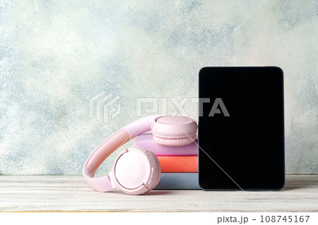 Stack of books and digital tablet on wooden desk 108745167