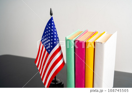 USA flag with pile of books against white background 108745505