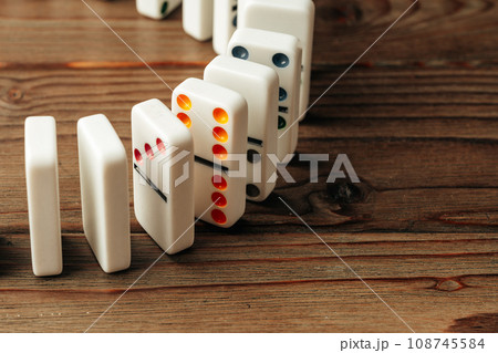 Domino tiles on wooden background close up Domino tiles on wooden background close up 108745584