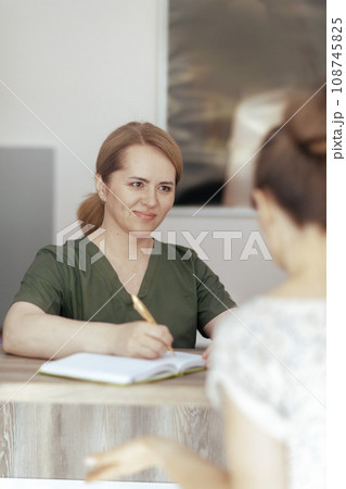 smiling female medical massage therapist in massage cabinet 108745825