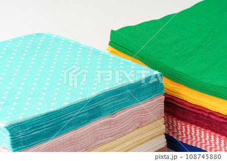Two stacks of colorful paper napkins on white background Two stacks of colorful paper napkins on white background 108745880