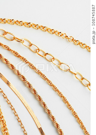 Jewelry set of golden chains on the white background Jewelry set of golden chains on the white background 108745887