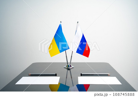 Russia and Ukraine flags on negotiation table 108745888