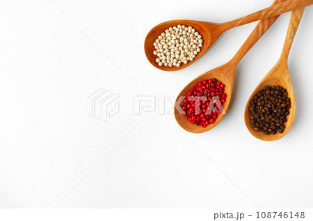 Wooden spoons with various spices isolated on white background 108746148