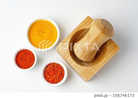 Wooden mortar with spices on white background 108746173