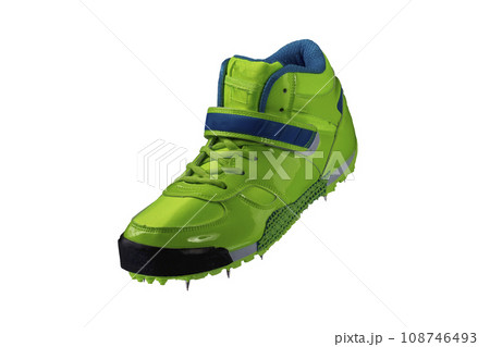 Green glossy sneaker with spikes on a white background. Sport shoes. 108746493