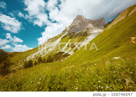 landscape with mountains, hills, clouds, meadow and trees landscape with mountains, hills, clouds, meadow and trees 108746847