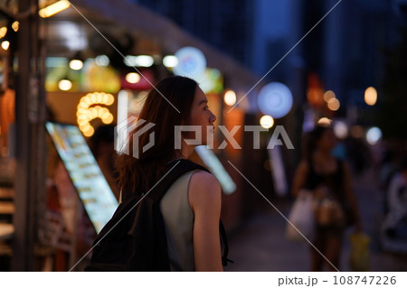 Young Adult Asian woman exploring a street market in Bangkok, Thailand. Female solo traveler on South East Asia vacation. Young Adult Asian woman exploring a street market in Bangkok, Thailand. Female solo traveler on South East Asia vacation. 108747226