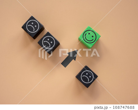 Cubes with sad faces and one with happy ones. Positive thinking and new mindset concept. Cubes with sad faces and one with happy ones. Positive thinking and new mindset concept. 108747688