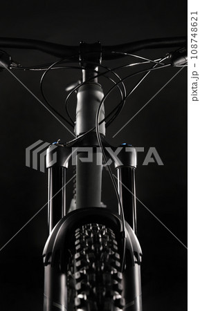 Mountain Bike Suspension Fork on Dark Background, Studio Shot Mountain Bike Suspension Fork on Dark Background, Studio Shot 108748621