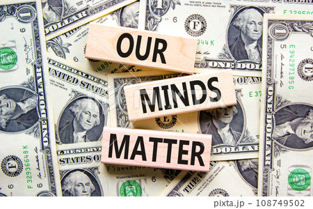 Our minds matter ourmindsmatter symbol. Concept words Our minds matter on wooden block. Dollar bills. Beautiful background from dollar bills. Our minds matter ourmindsmatter concept. Copy space. 108749502