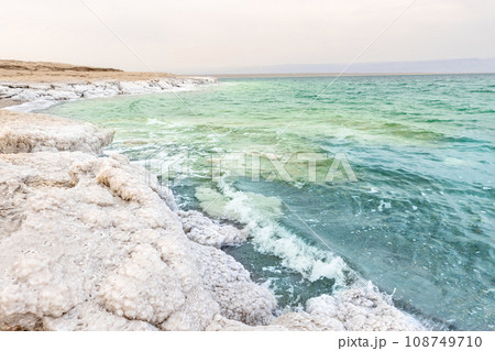 Deposits of mineral salts, typical landscape of the Dead Sea in Jordan. 108749710