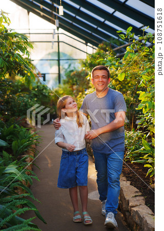 fun Dad and daughter are a teenager on a walk in the botanical garden. fun Dad and daughter are a teenager on a walk in the botanical garden. 108751618
