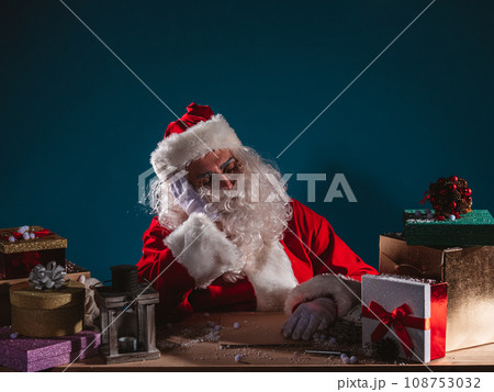 Tired santa claus is sleeping due to christmas overwork Tired santa claus is sleeping due to christmas overwork 108753032