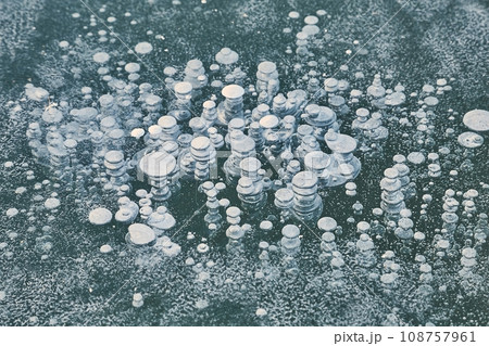 Winter ice with gas bubbles trapped inside Winter ice with gas bubbles trapped inside 108757961