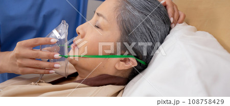 Nurse putting oxygen mask with patient elderly woman on bed for diagnose and healing in hospital. Nurse putting oxygen mask with patient elderly woman on bed for diagnose and healing in hospital. 108758429