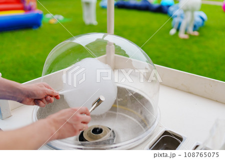 Making cotton candy at a children's party.  108765075
