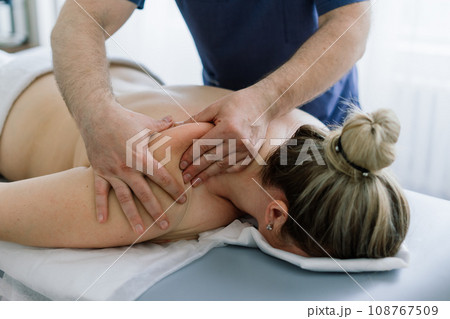 Young fat woman getting massage treatment in day spa cabinet. Young fat woman getting massage treatment in day spa cabinet. 108767509