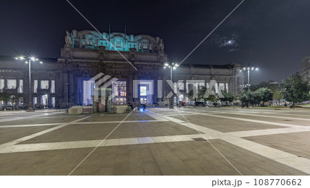 Panorama showing Milano Centrale night timelapse - the main central railway station of the city of Milan in Italy. Panorama showing Milano Centrale night timelapse - the main central railway station of the city of Milan in Italy. 108770662