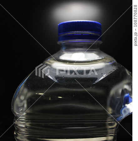 The blue cap tightly closes the neck of the purified water  in a plastic bottle 108770828