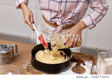 female hands baking in white modern kitchen 108773043