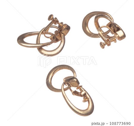 Fashion gold Earrings with beautiful work detail is value. Luxury golden earring is fashion trend and fly in air. White background isolated Fashion gold Earrings with beautiful work detail is value. Luxury golden earring is fashion trend and fly in air. White background isolated 108773690