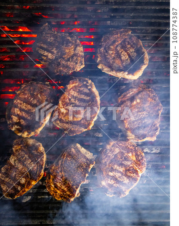 Steaks are generously covered in seasoning Steaks are generously covered in seasoning 108774387
