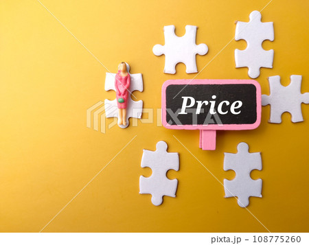 White puzzle and miniature people with text Price on a yellow background. White puzzle and miniature people with text Price on a yellow background. 108775260