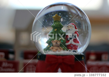 Snow Globe with Santa Claus. Christmas or New Year gift, Close up view, selective focus Snow Globe with Santa Claus. Christmas or New Year gift, Close up view, selective focus 108777102