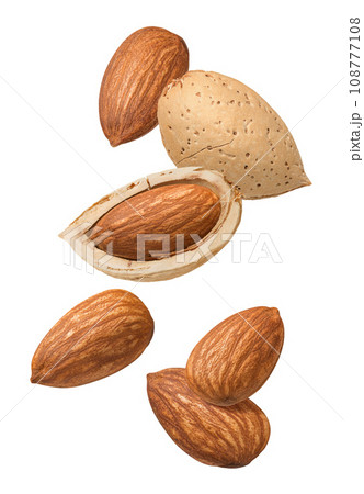 Flying almonds in shell isolated on white background. 108777108