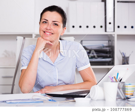 Portrait of young smiling female in the office 108777869