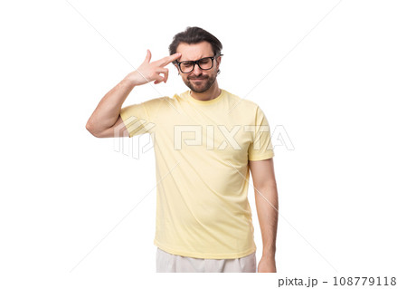 portrait of a casual caucasian guy with a beard in glasses dressed in a light t-shirt on a white 108779118