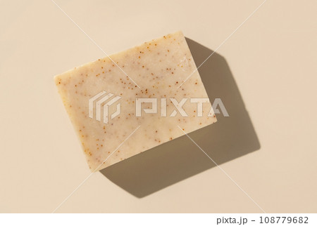 Natural herbal beige soap bar on light beige top view, hard shadows 108779682