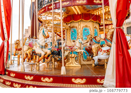 Children’s vintage carousel in the form of horses in a holiday park. 108779773