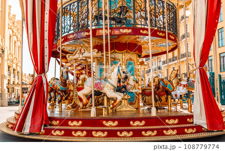 Children’s vintage carousel in the form of horses in a holiday park. 108779774