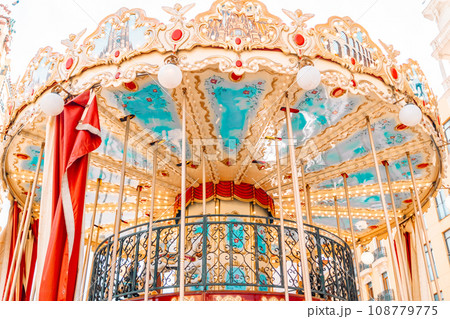 Children’s vintage carousel in the form of horses in a holiday park. 108779775