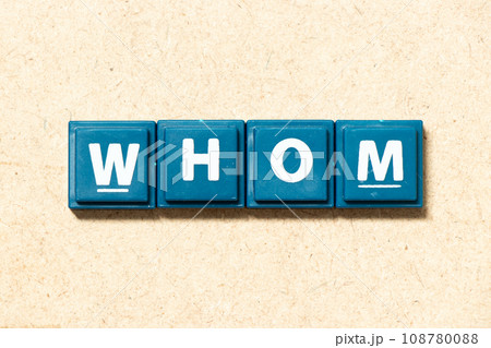 Tile alphabet letter in word whom on wood background 108780088