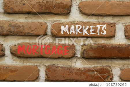 Mortgage markets symbol. Concept words Mortgage markets on beautiful brown brick wall. Beautiful brown brick wall background. Business mortgage markets concept. Copy space. 108780262