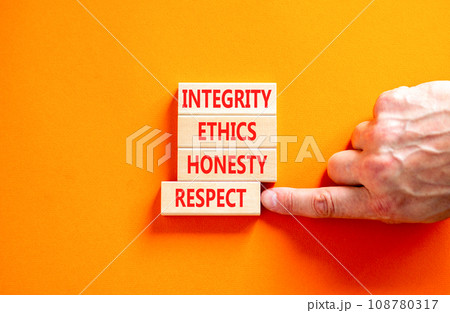 Integrity ethics honesty respect symbol. Concept word Integrity Ethics Honesty Respect on block. Beautiful orange background. Businessman hand. Business integrity ethics honesty respect concept. 108780317