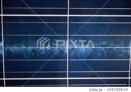 Photovoltaic solar panels getting clean energy from the sun. Dark blue solar battery on roof of the house. Concept of alternative energy, modern innovations and green energy. 108780629
