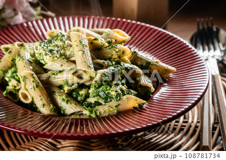 Penne pasta with spinach and chicken. 108781734