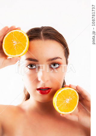 Young woman with orange halves in her  108781737