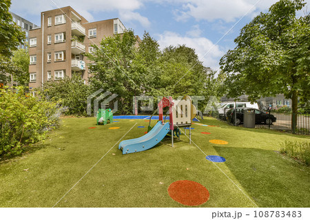 an outdoor play area with children's playground equipment and trees in the fore - image is taken from above an outdoor play area with children's playground equipment and trees in the fore - image is taken from above 108783483