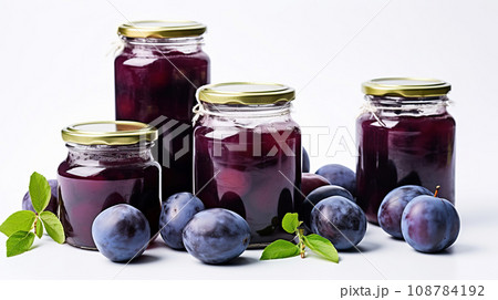 Jar of jam on a white background. Glass jar of plum compote and fresh plums on a white table. Jar of jam on a white background. Glass jar of plum compote and fresh plums on a white table. 108784192