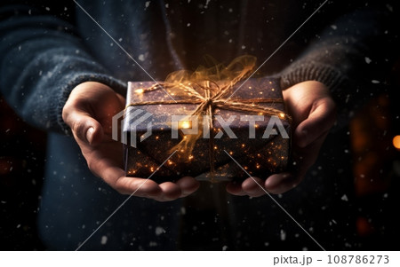 Close up of man hands holding christmas gift box. Mixed media 108786273