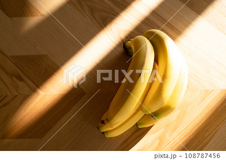 Ripe bananas bunch on the wooden background 108787456